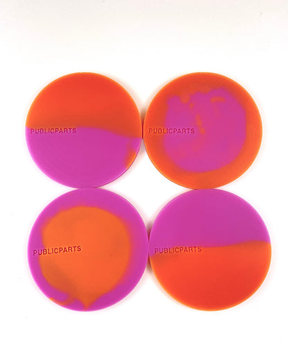 Set of four orange and pink heat-reactive silicone coasters hand-poured in London