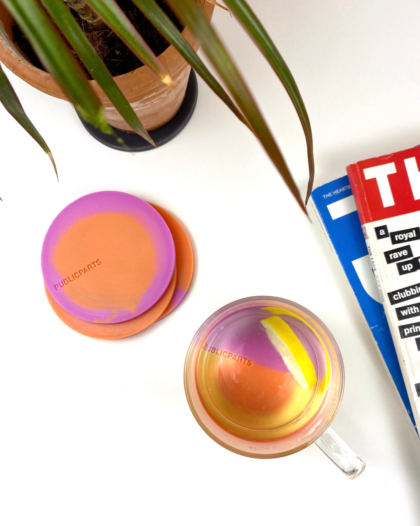 Stacked orange and pink silicone coasters with soft thermochromic gradient.