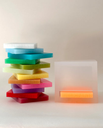 PUBLICPARTS Gel Lamp with orange colour gel beside a stack of interchangeable silicone gels