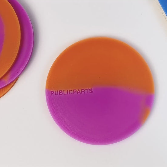 Video showing heat-reactive silicone coasters changing colour when a hot cup is placed on them.